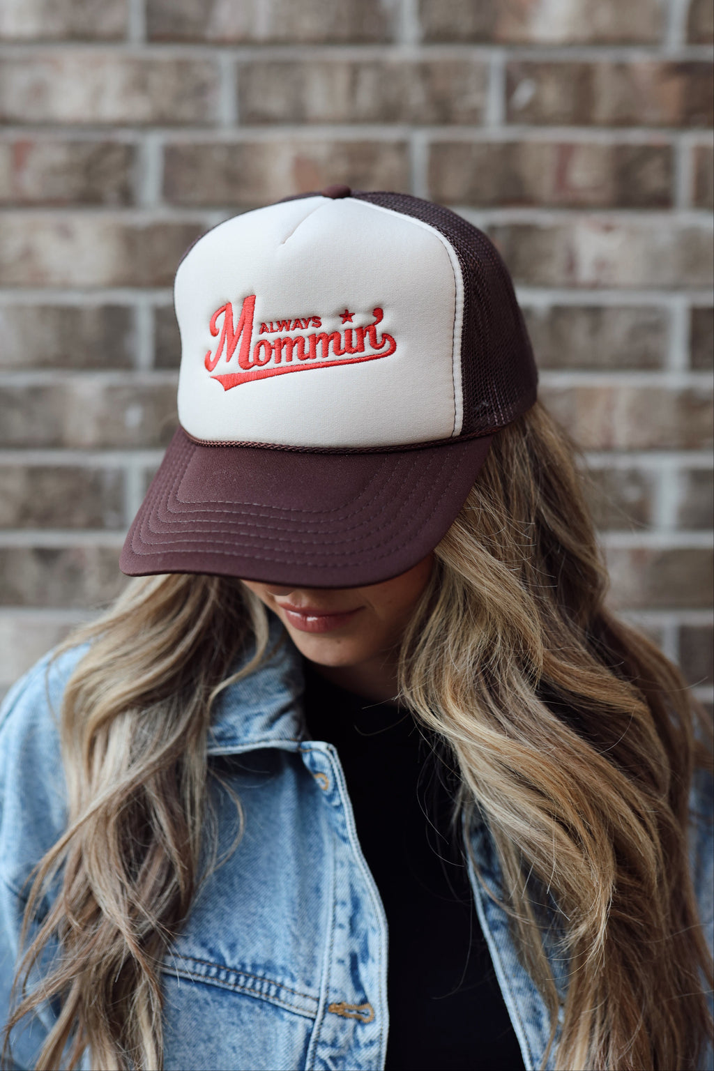 Mom trucker hat that says always mommin with red thread and a brown hat